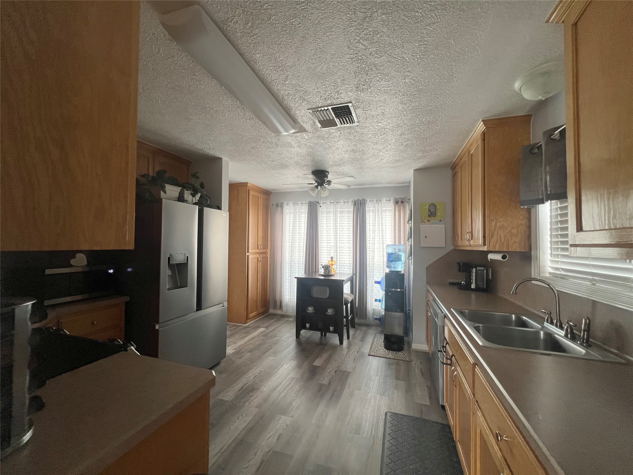 2305 Katherine Street Brenham, TX 77833 - Photo 13 of 37 a kitchen with a sink appliances and wooden floor