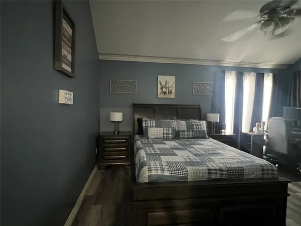 a bedroom with a bed and a chandelier