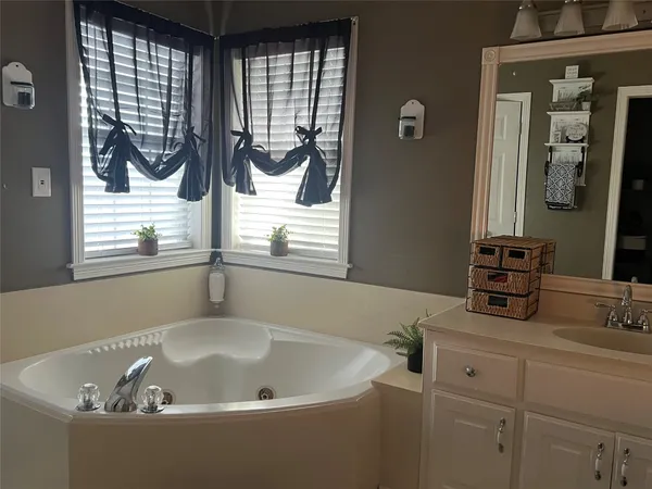 a bath tub sitting in a bathroom next to a window
