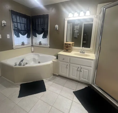 a bathroom with a bathtub sink and mirror