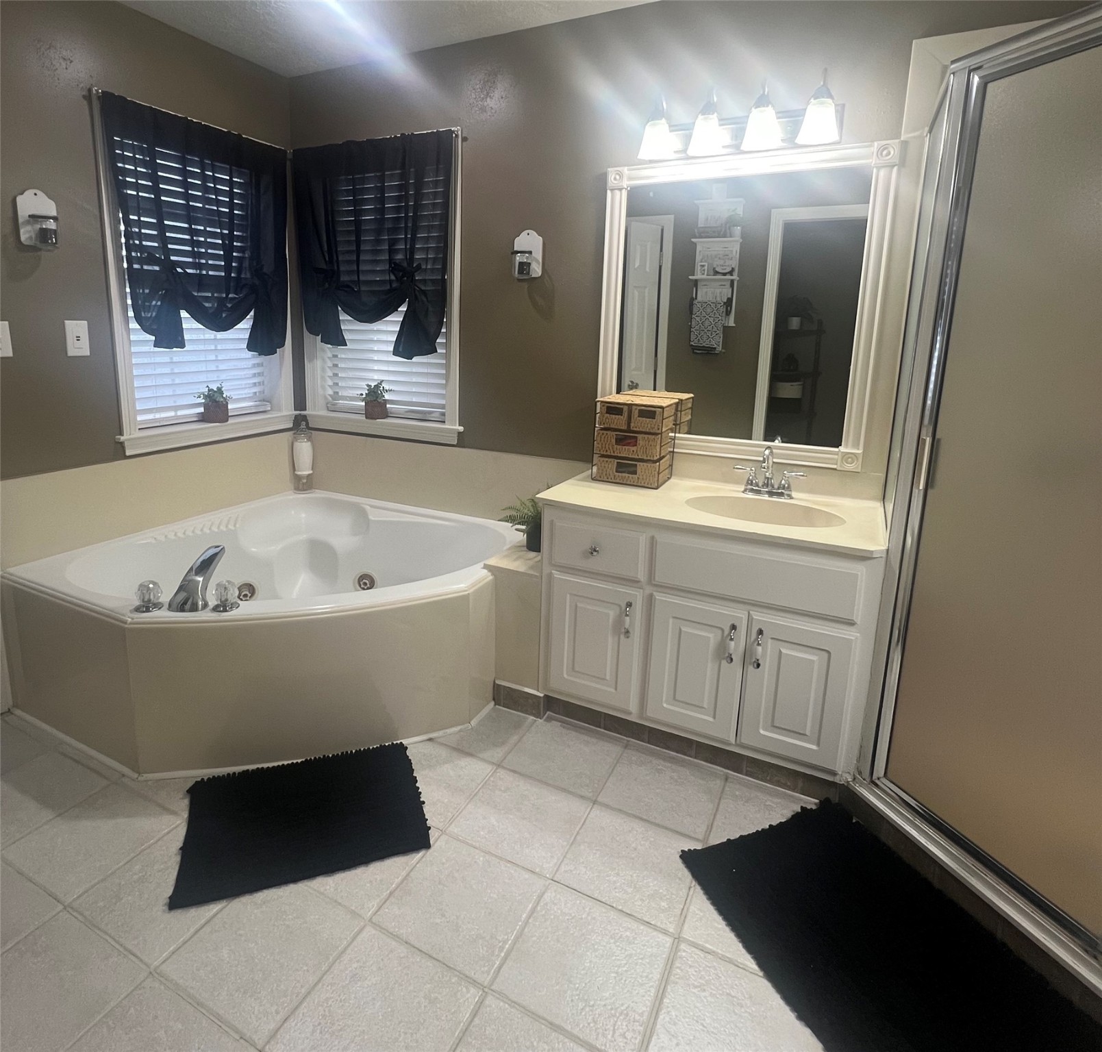 2305 Katherine Street Brenham, TX 77833 - Photo 27 of 37 a bathroom with a bathtub sink and mirror