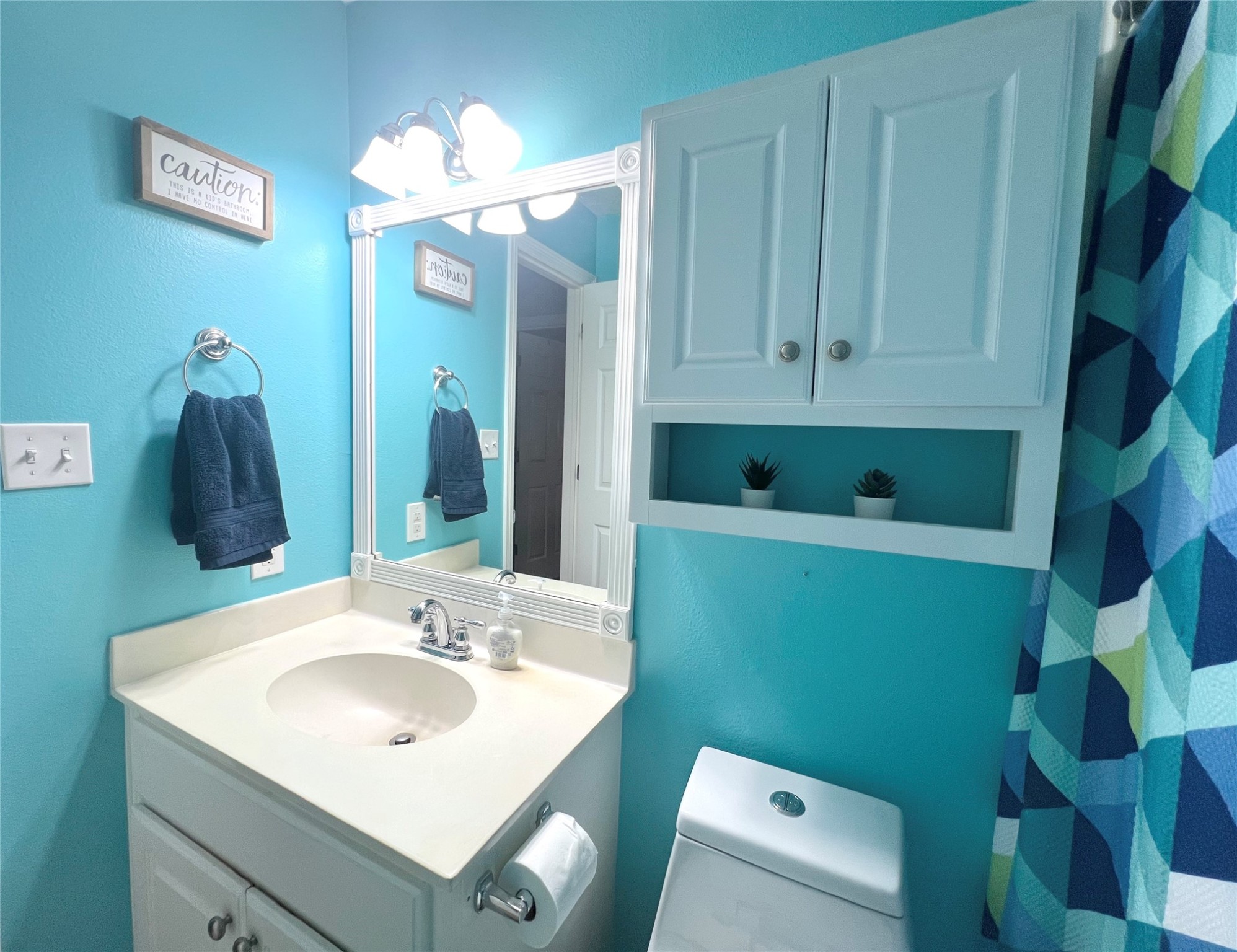 2305 Katherine Street Brenham, TX 77833 - Photo 31 of 37 a bathroom with a sink a mirror and a toilet