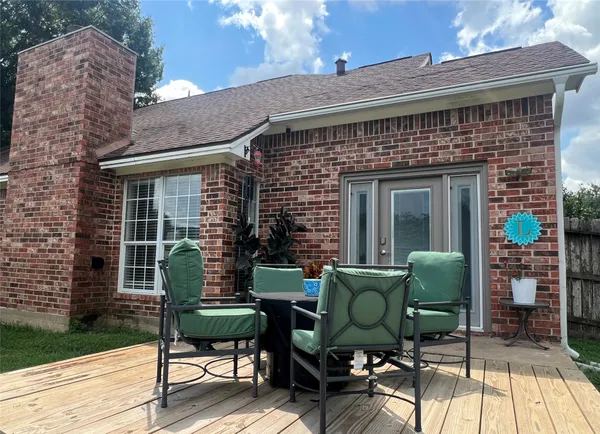 a view of a two chairs in the patio