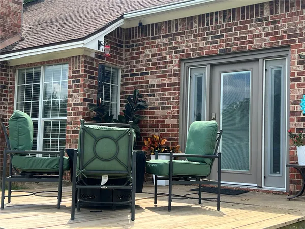 a view of a two chairs in the balcony