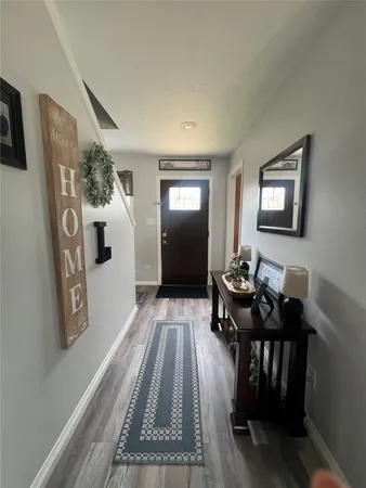 a view of a livingroom with furniture and wooden floor