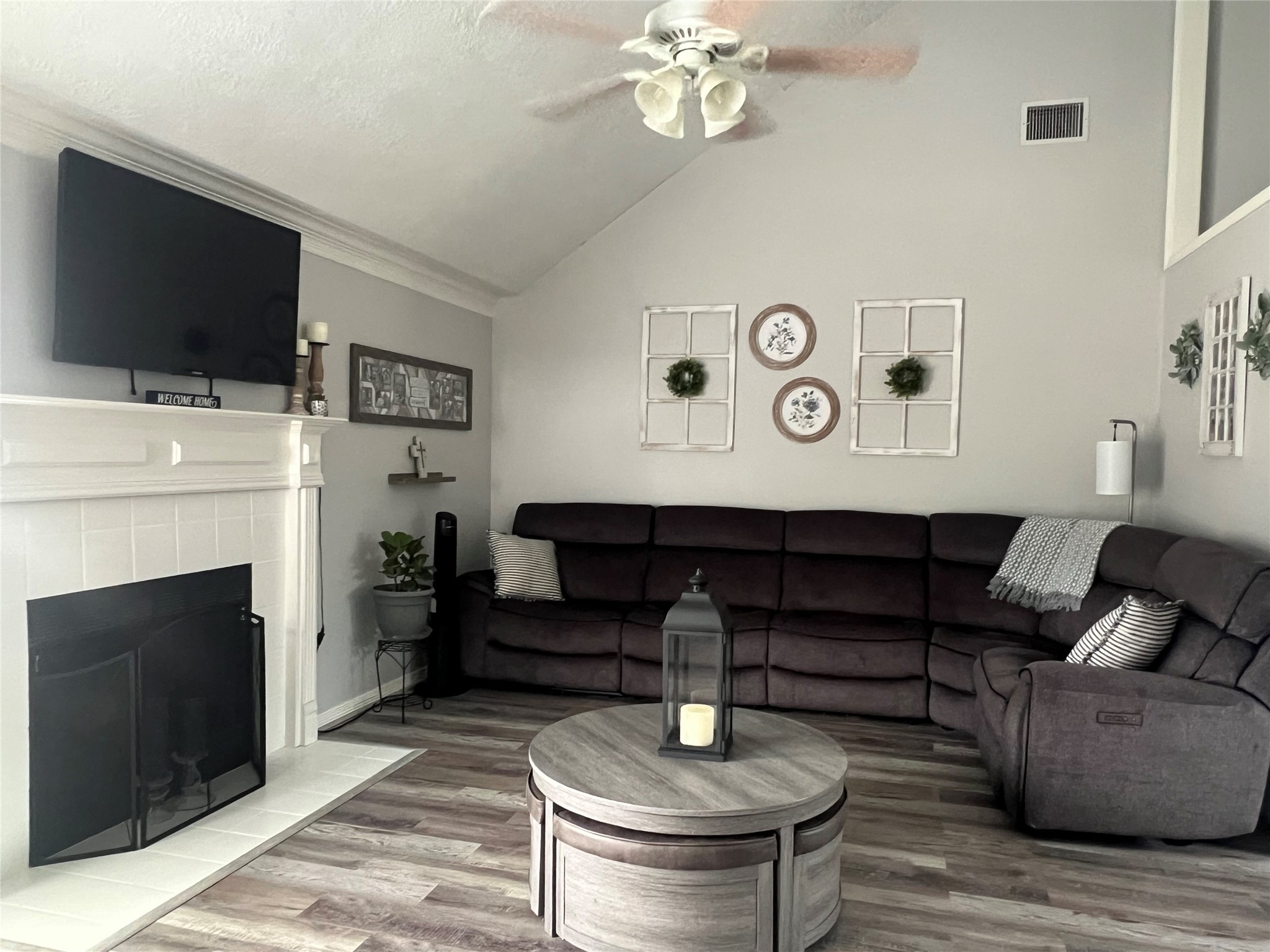 2305 Katherine Street Brenham, TX 77833 - Photo 7 of 37 a living room with furniture a flat screen tv and a fireplace