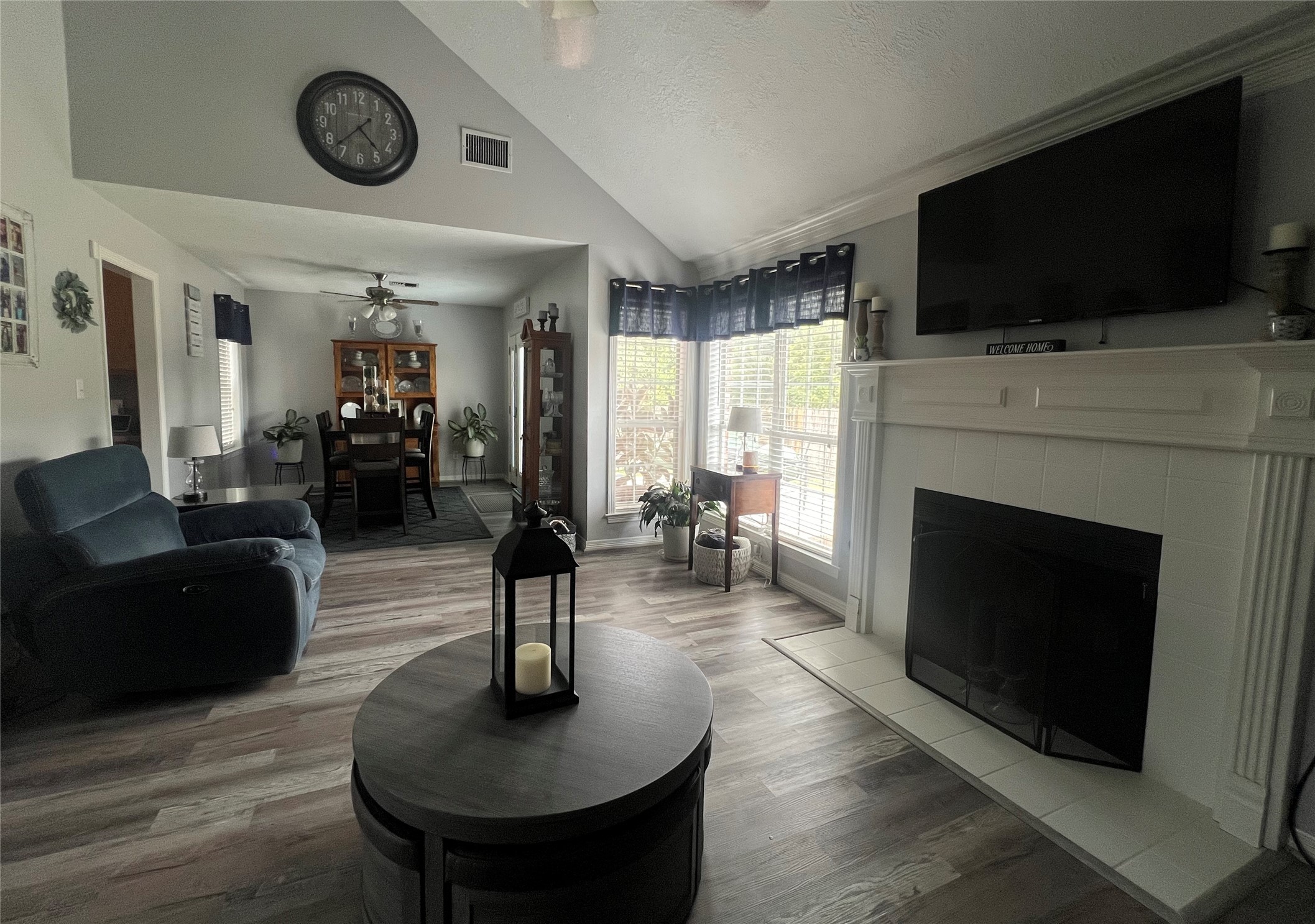 2305 Katherine Street Brenham, TX 77833 - Photo 9 of 37 a living room with furniture a flat screen tv and a fireplace