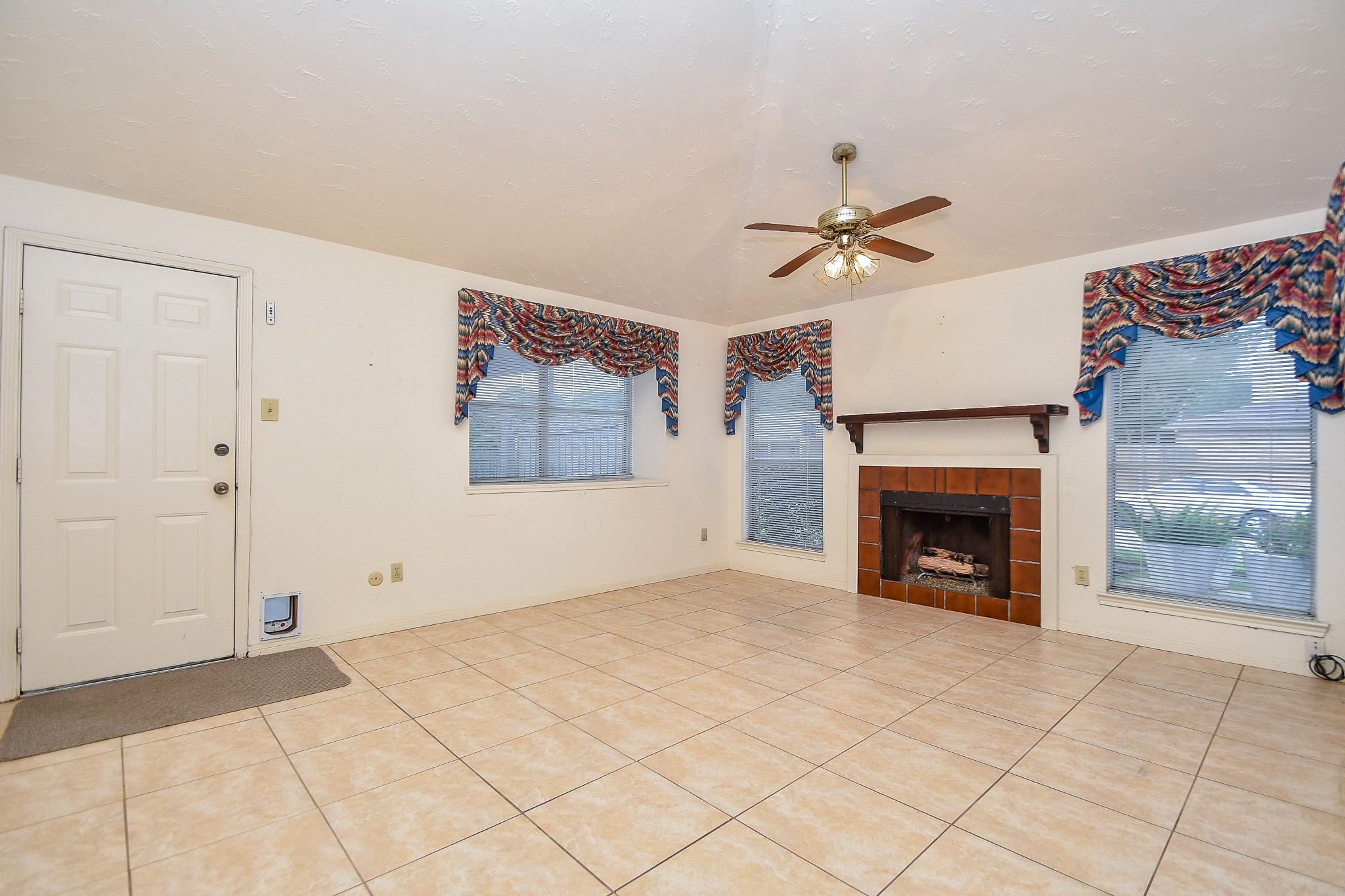 8323 East Ridge Drive Houston, TX 77040 - Photo 11 of 31 an empty room with fireplace and fan