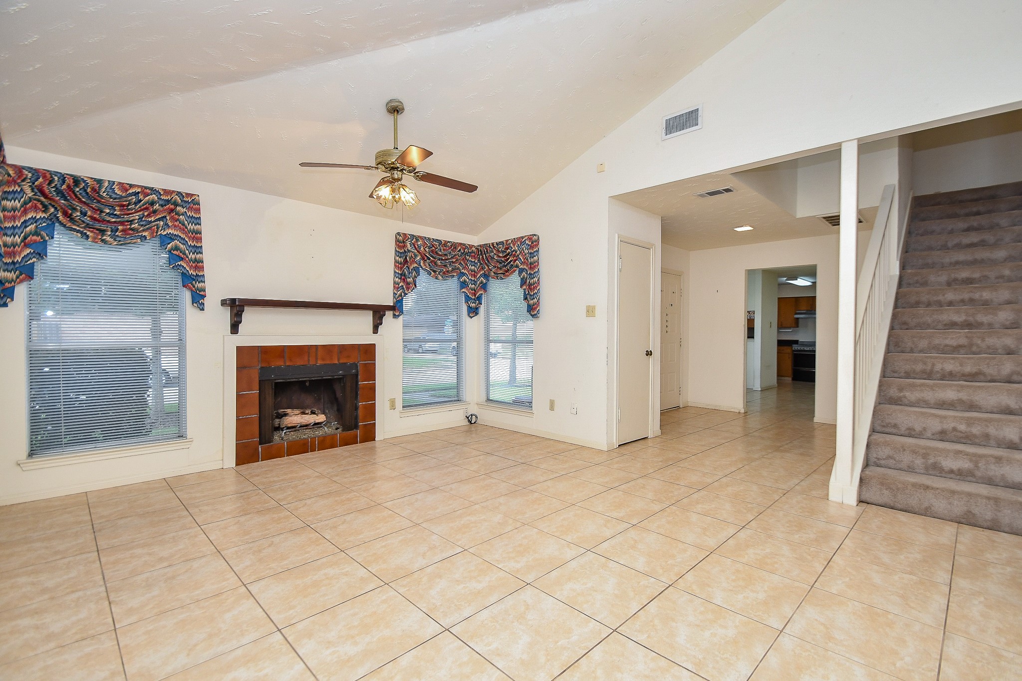 8323 East Ridge Drive Houston, TX 77040 - Photo 13 of 31 an empty room with fireplace and fan