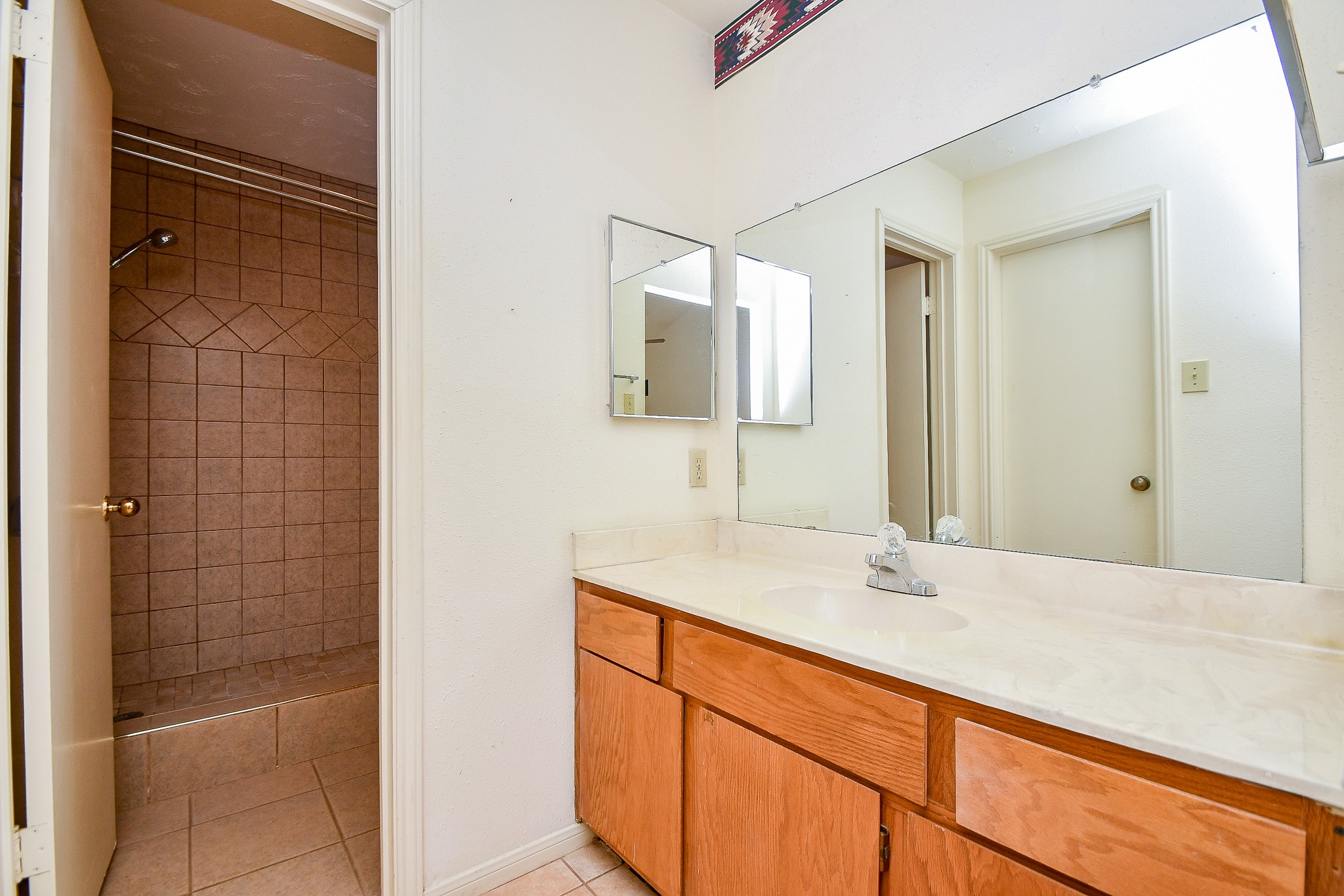 8323 East Ridge Drive Houston, TX 77040 - Photo 18 of 31 a bathroom with a sink and a mirror