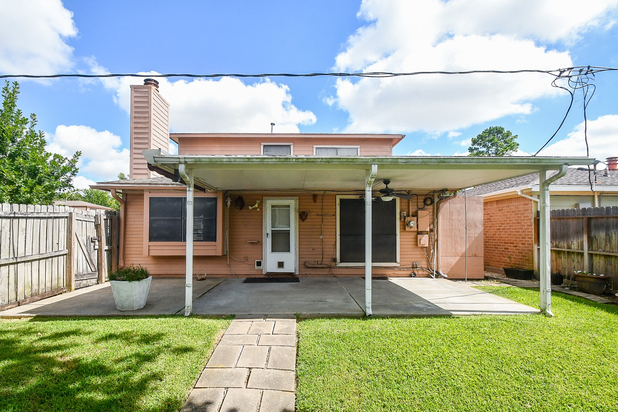 8323 East Ridge Drive Houston, TX 77040 - Photo 3 of 31 a view of a house with a porch and a floor to ceiling window