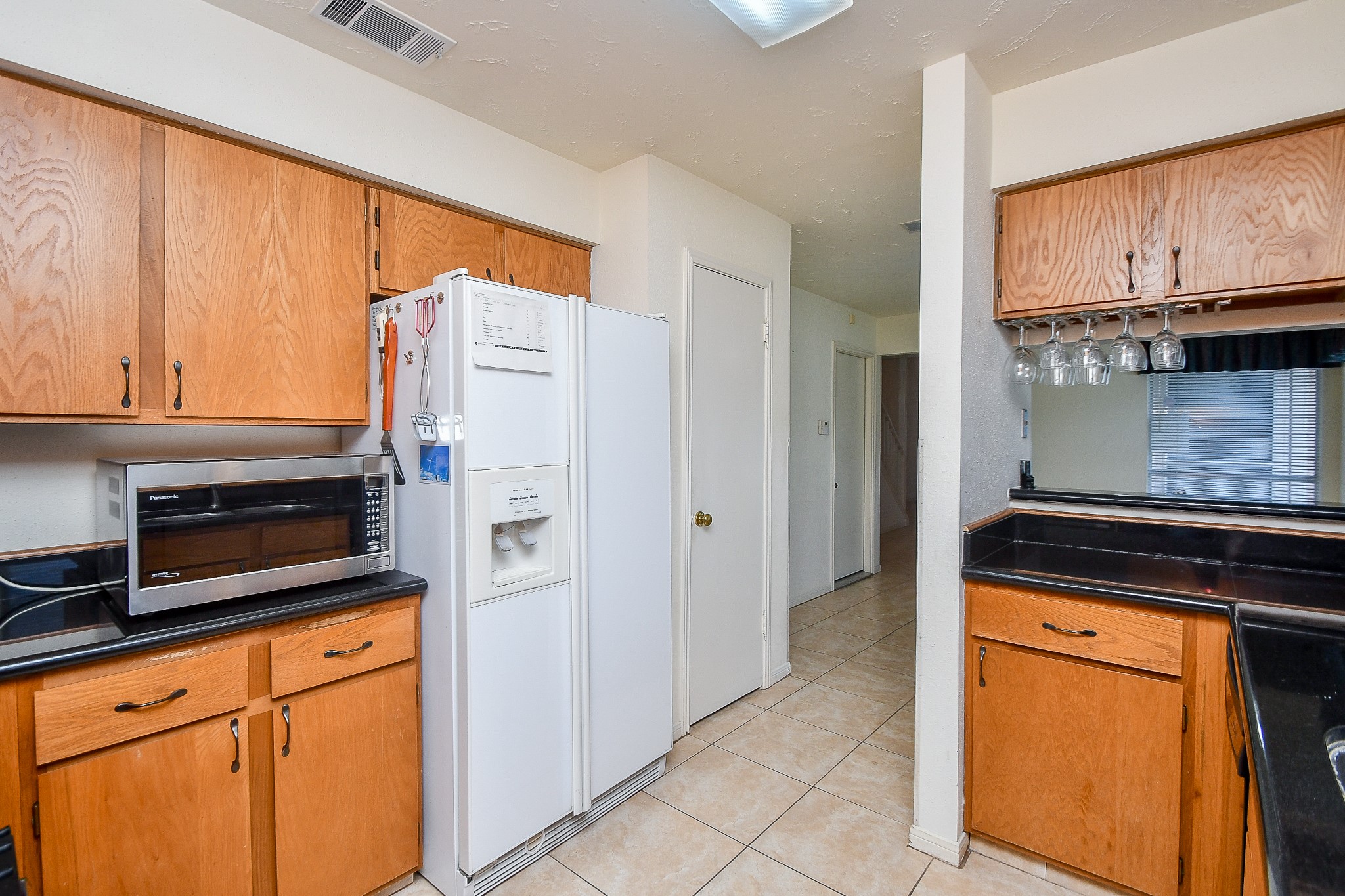8323 East Ridge Drive Houston, TX 77040 - Photo 8 of 31 a kitchen with stainless steel appliances granite countertop a refrigerator and cabinets