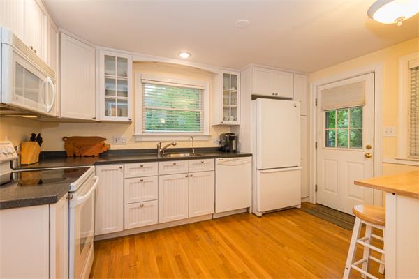 52 Paul Revere Road Lexington, MA 02421 - Photo 11 of 20 a kitchen with a refrigerator sink and cabinets