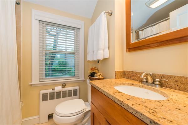 52 Paul Revere Road Lexington, MA 02421 - Photo 16 of 20 a bathroom with a granite countertop sink toilet and mirror