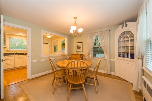 52 Paul Revere Road Lexington, MA 02421 - Photo 8 of 20 a dining room with wooden floor a chandelier a wooden table and chairs