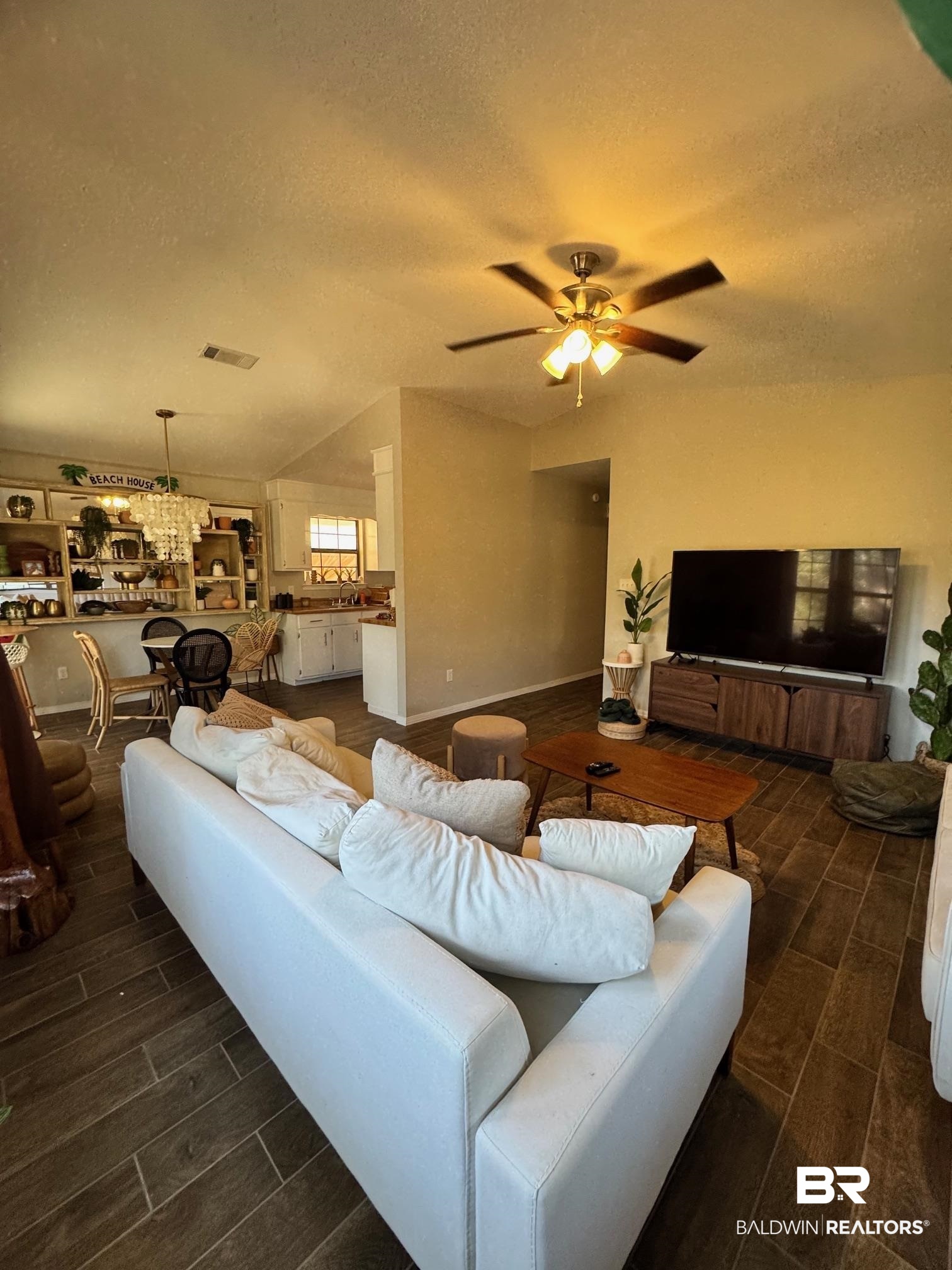 1434 Ridgewood Drive Lillian, AL 36549 - Photo 13 of 45 Living room featuring ceiling fan and a textured ceiling