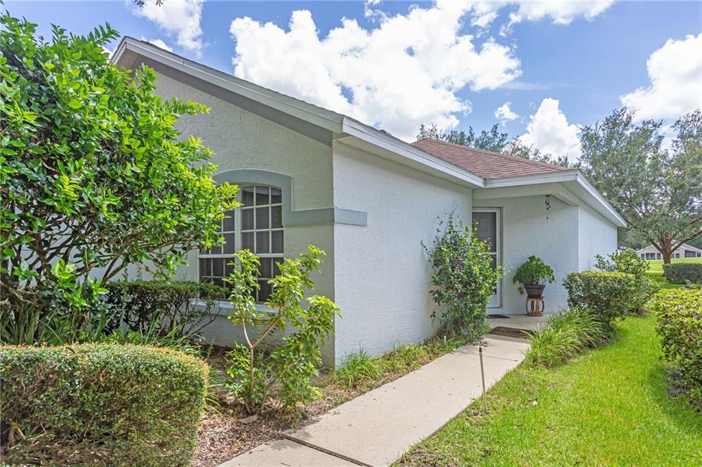 3030 Andover Court Mount Dora, FL 32757 - Photo 1 of 1 a front view of a house with garden