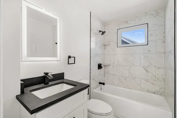 a bathroom with a sink toilet and shower