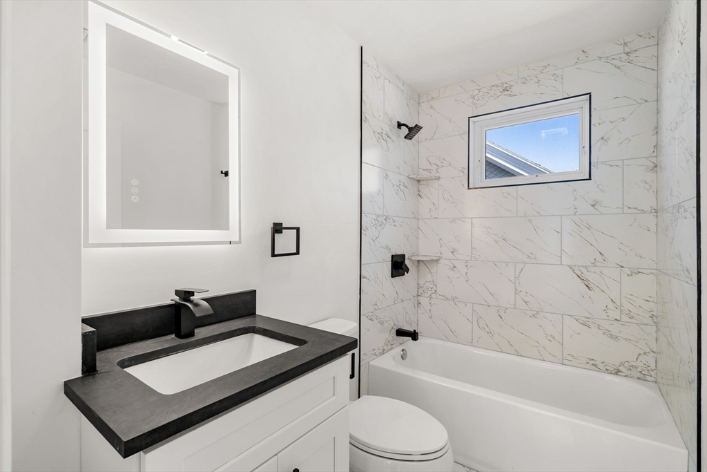 55 Dustin Street, Unit 3 Boston, MA 02135 - Photo 14 of 22 a bathroom with a sink toilet and shower