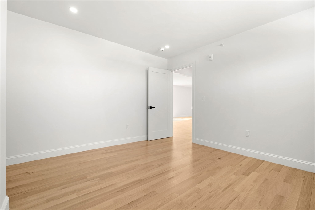 55 Dustin Street, Unit 3 Boston, MA 02135 - Photo 15 of 22 a view of an empty room with wooden floor