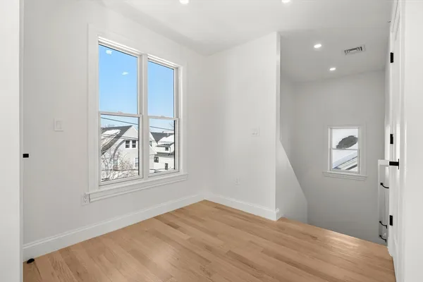 an empty room with windows and closet