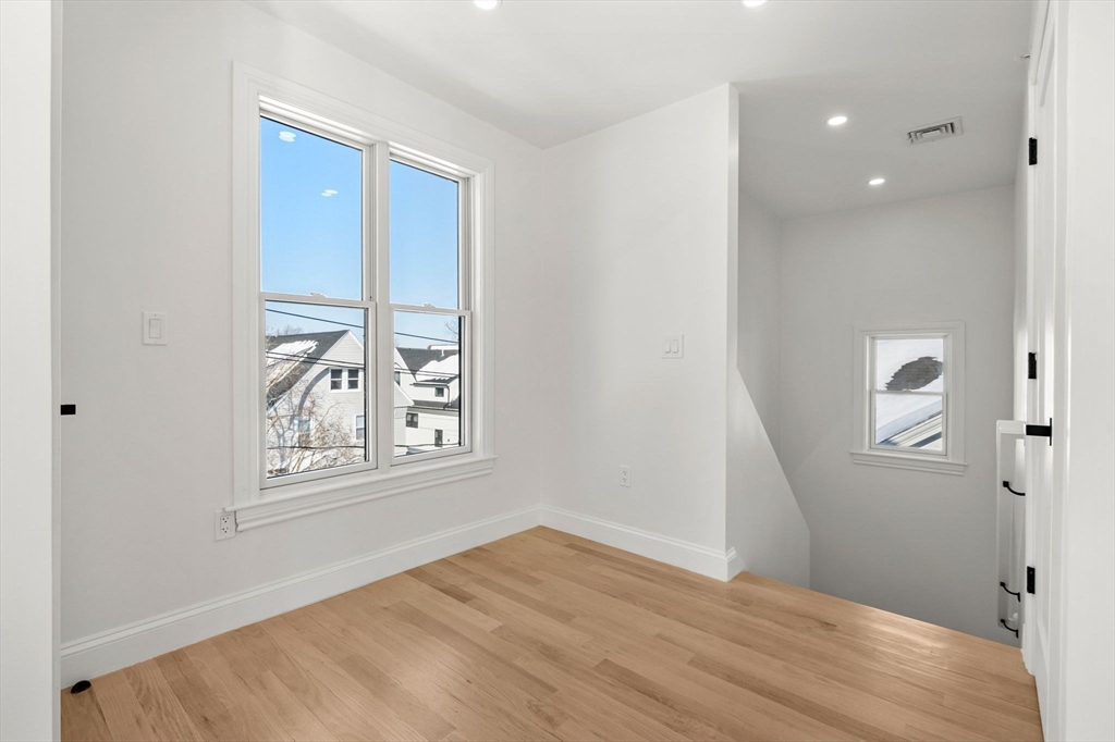 55 Dustin Street, Unit 3 Boston, MA 02135 - Photo 18 of 22 an empty room with windows and closet