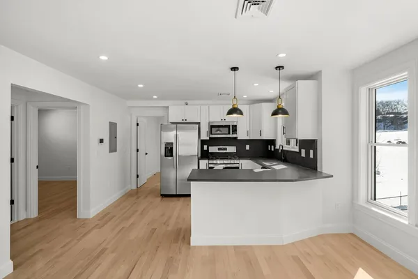 a kitchen with stainless steel appliances granite countertop a sink and a stove