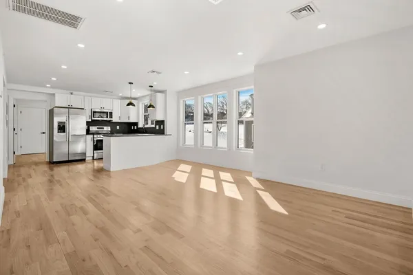 a view of a kitchen with wooden floor