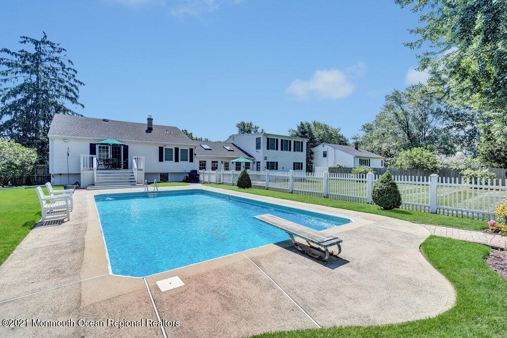 50 Lone Oak Road Middletown, NJ 07748 - Photo 12 of 38 a swimming pool with outdoor seating and yard