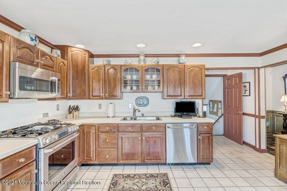 50 Lone Oak Road Middletown, NJ 07748 - Photo 25 of 38 a kitchen with stainless steel appliances a stove a sink and a refrigerator
