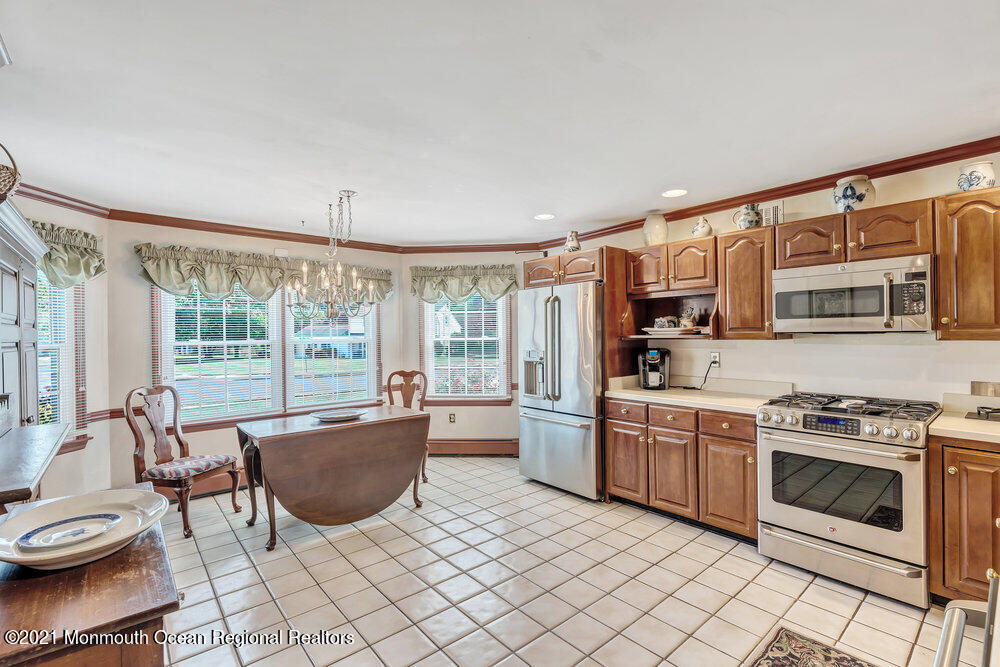 50 Lone Oak Road Middletown, NJ 07748 - Photo 26 of 38 a kitchen with furniture a stove and a view of living room
