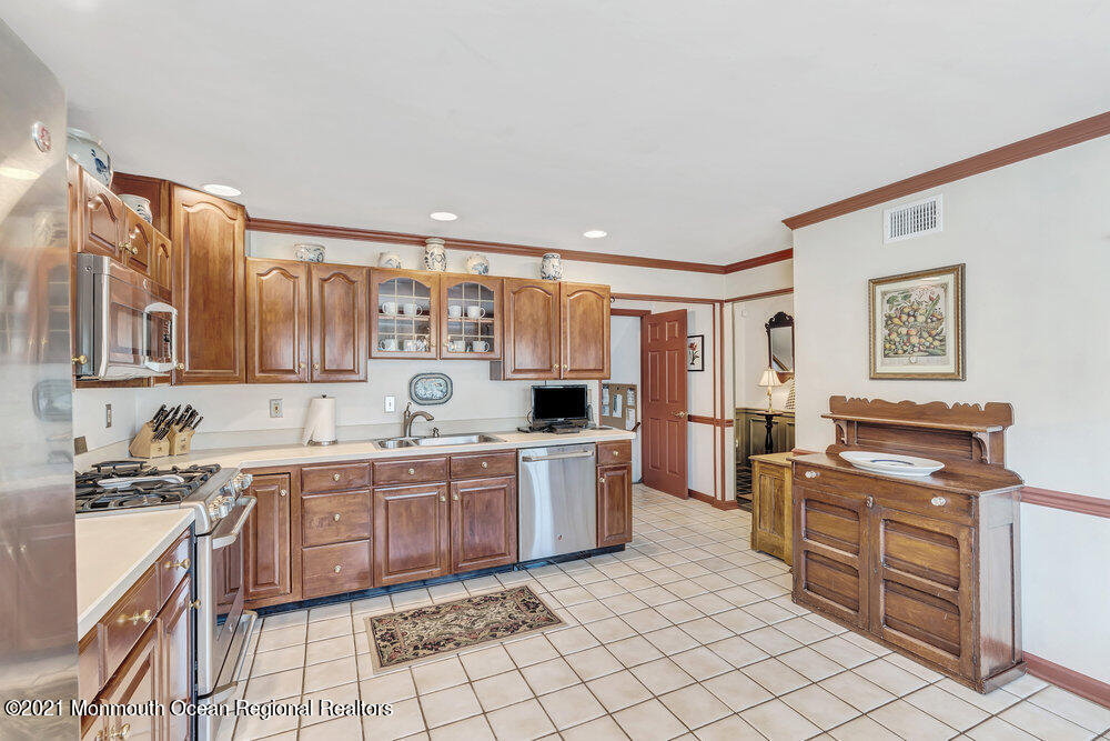 50 Lone Oak Road Middletown, NJ 07748 - Photo 28 of 38 a kitchen with a sink stove and cabinets