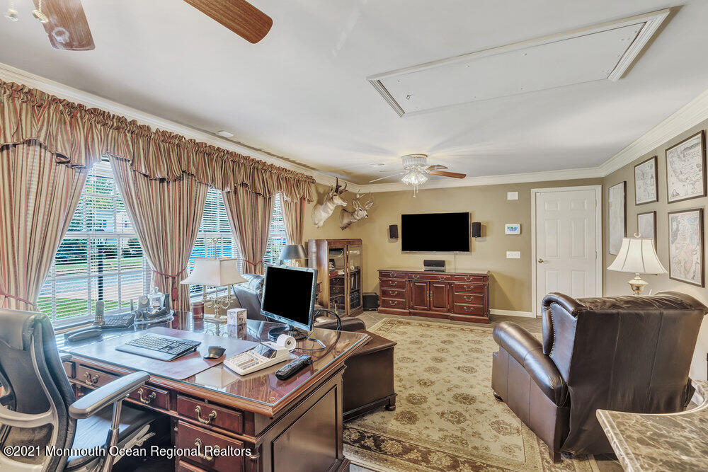 50 Lone Oak Road Middletown, NJ 07748 - Photo 29 of 38 a living room with furniture a flat screen tv and a large window