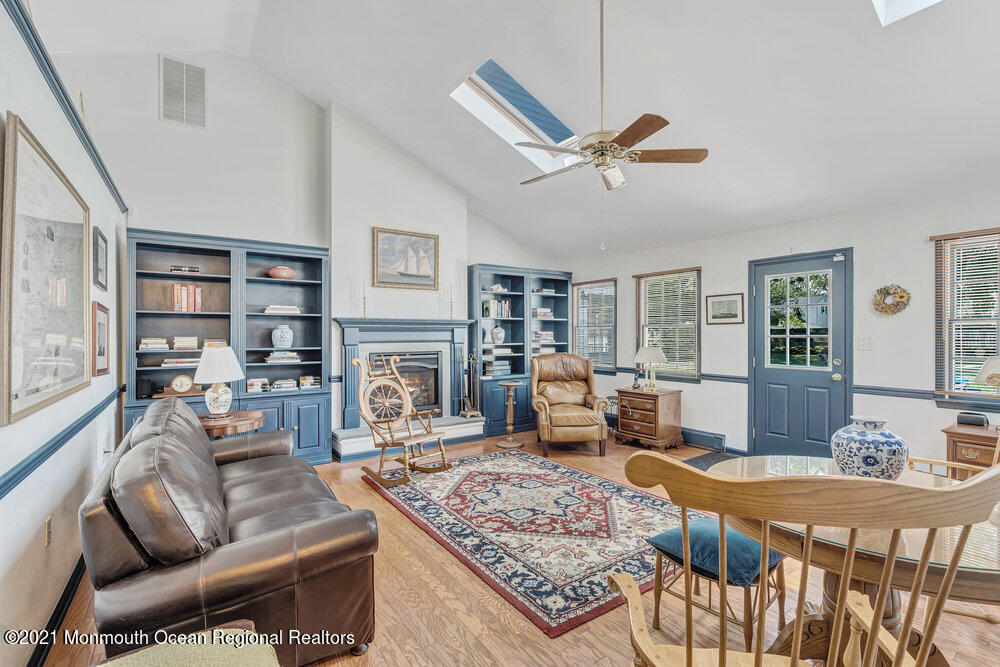 50 Lone Oak Road Middletown, NJ 07748 - Photo 32 of 38 a living room with fireplace furniture and a table