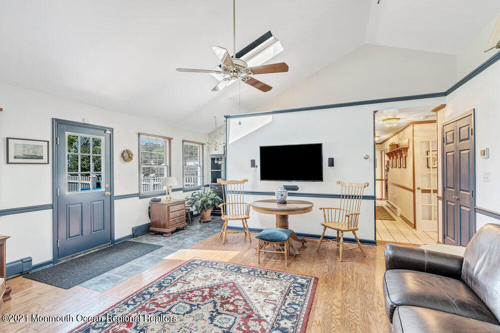 50 Lone Oak Road Middletown, NJ 07748 - Photo 33 of 38 a living room with furniture wooden floor and a flat screen tv