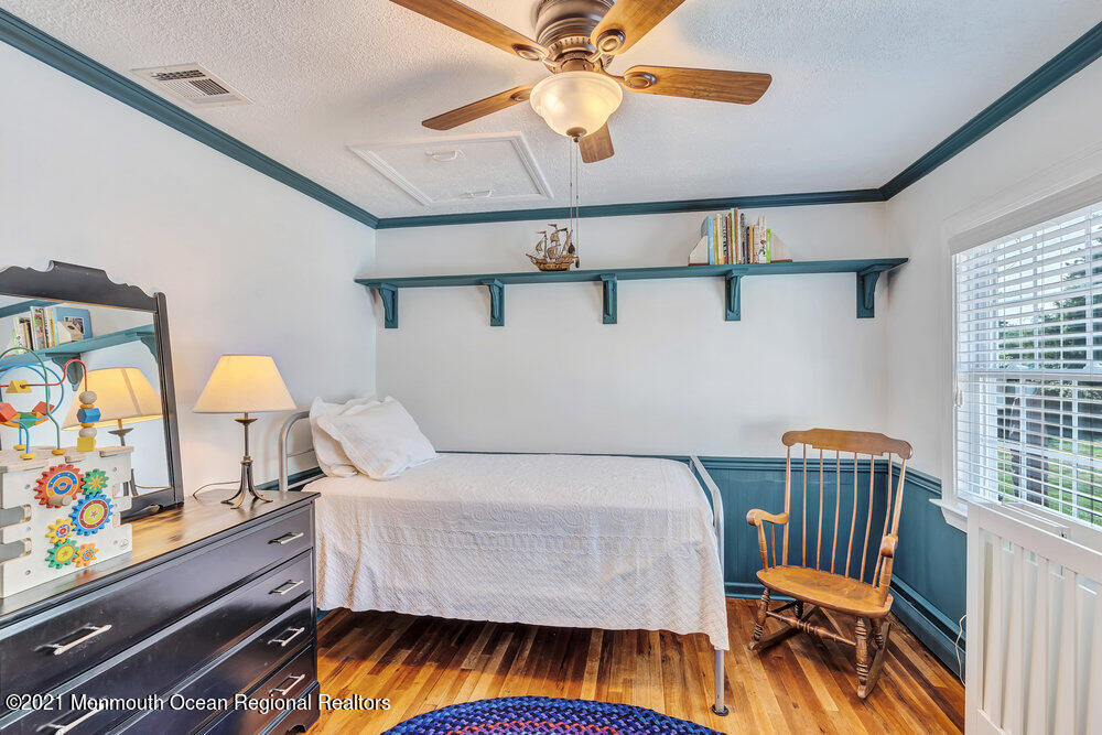 50 Lone Oak Road Middletown, NJ 07748 - Photo 7 of 38 a bedroom with a bed and a chandelier