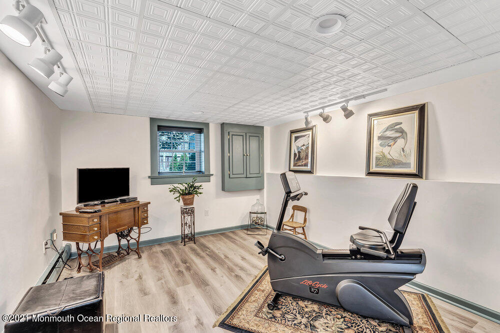 50 Lone Oak Road Middletown, NJ 07748 - Photo 10 of 38 a living room with furniture a wooden floor and a flat screen tv