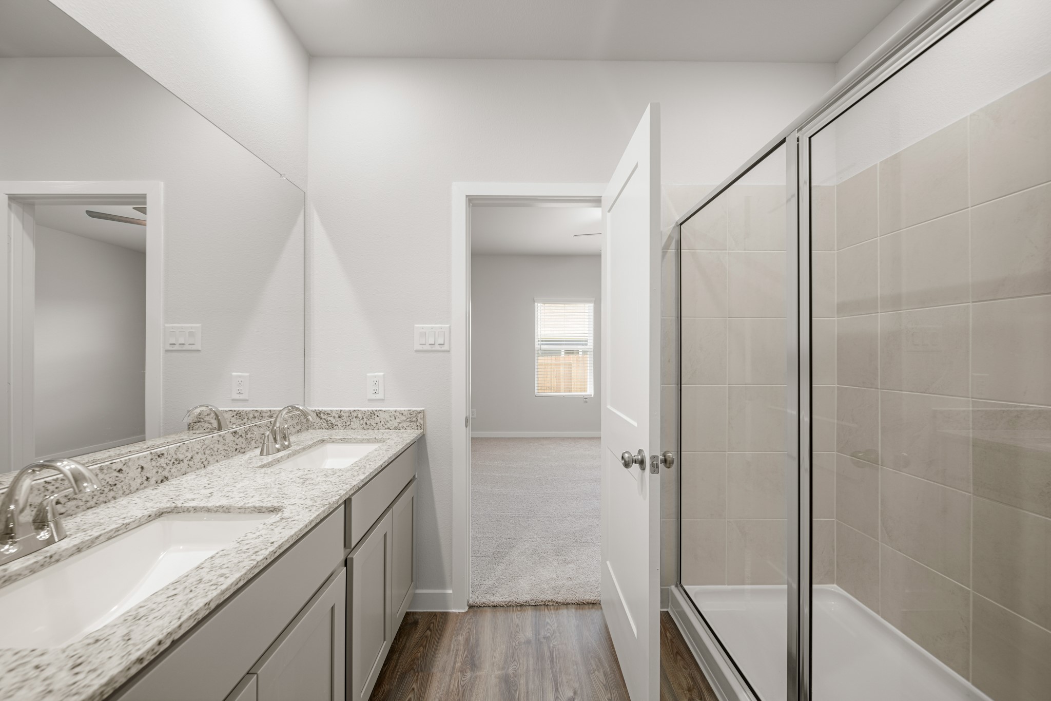 325 Bennett Street Angleton, TX 77515 - Photo 14 of 28 a bathroom with a granite countertop sink a mirror and shower
