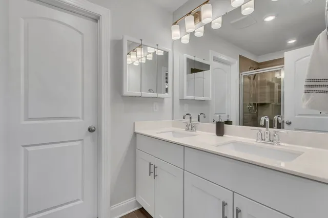 a bathroom with a sink vanity and mirror
