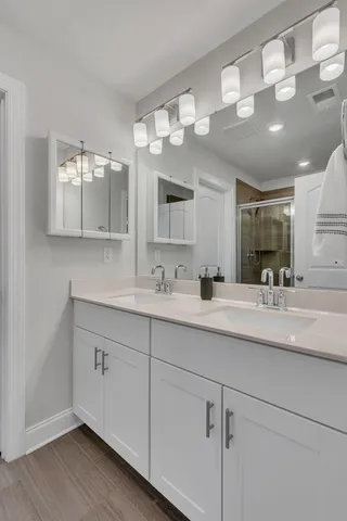a bathroom with a sink vanity and mirror