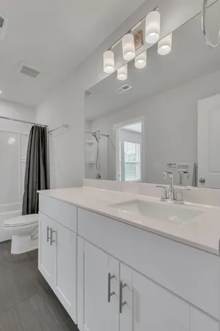 a spacious bathroom with a double vanity sink and a mirror
