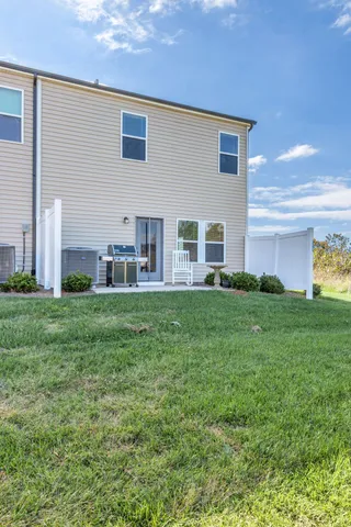 a view of house with backyard