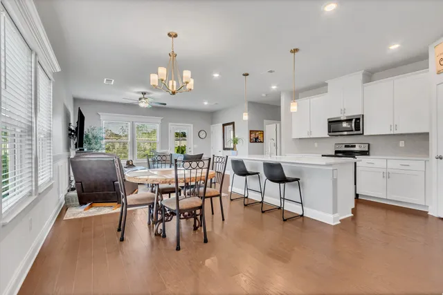 a view of a dining room with furniture and a chandelier