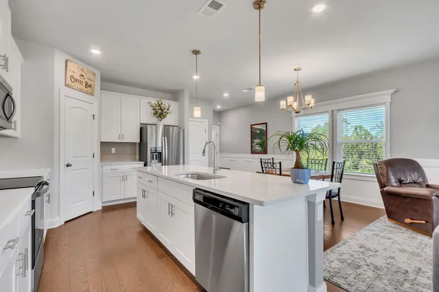 a kitchen with counter top space appliances and windows
