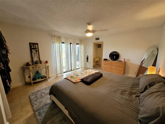 a bedroom with a bed and a large mirror on the dresser