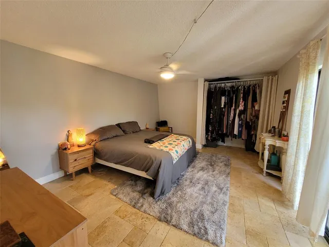 a spacious bedroom with a bed and a walk in closet