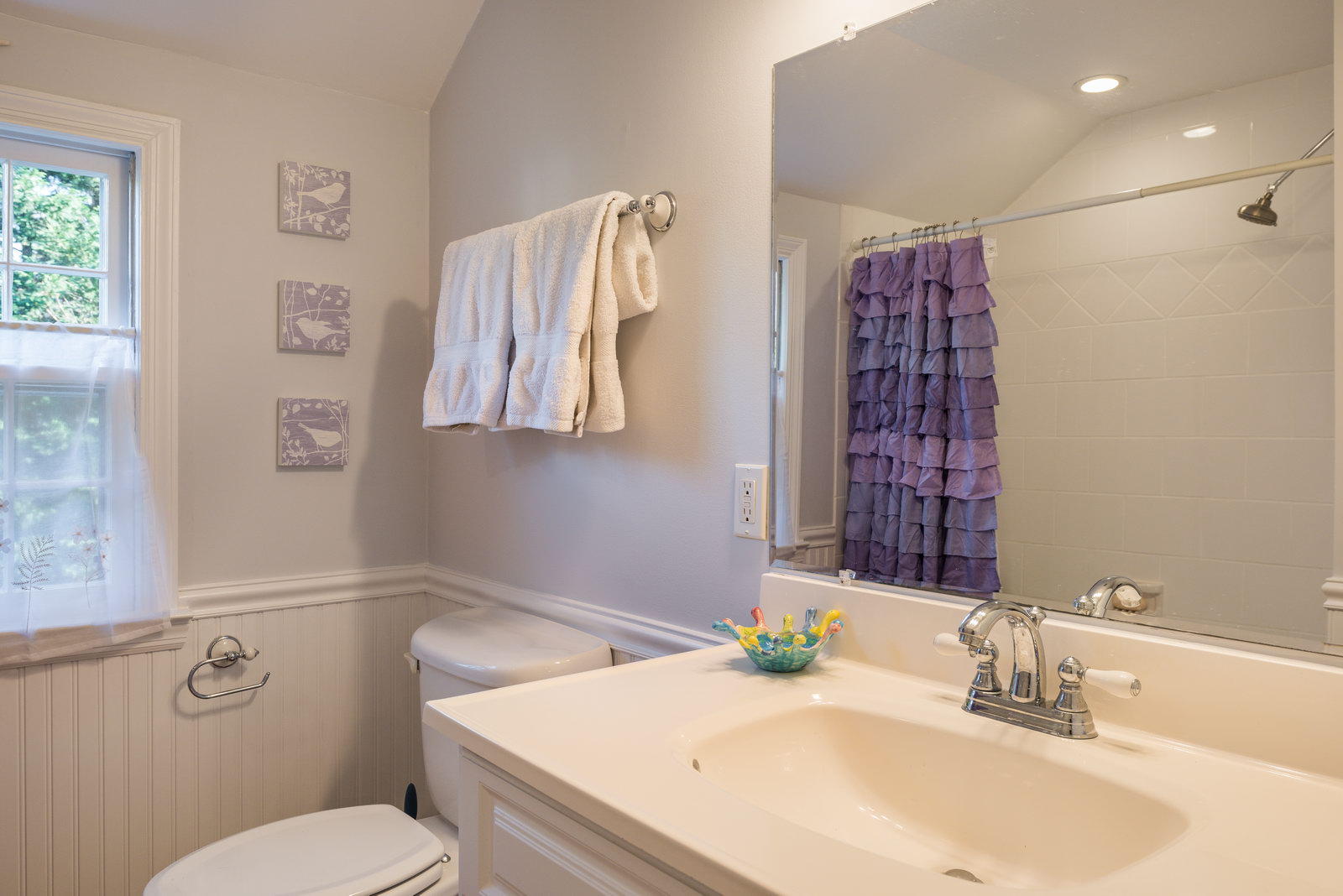 19 Birch Road Darien, CT 06820 - Photo 17 of 21 a bathroom with a sink a toilet and shower curtain