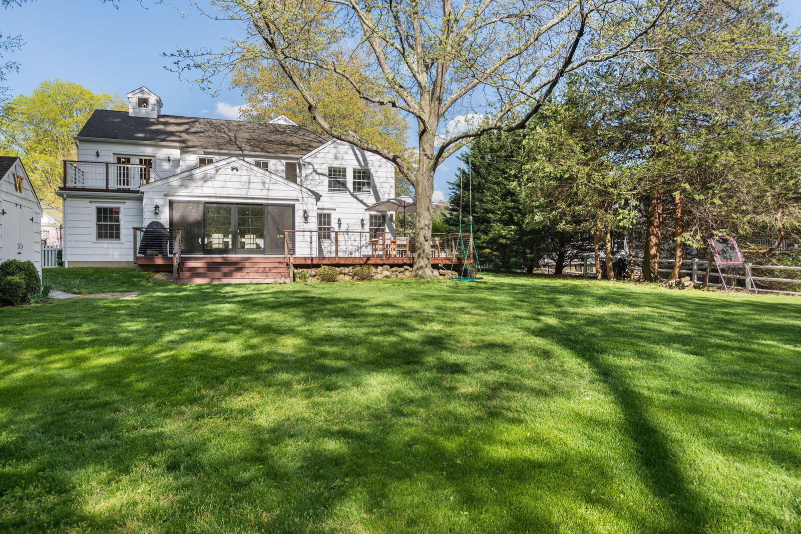 19 Birch Road Darien, CT 06820 - Photo 5 of 21 a view of a house with a big yard and large trees