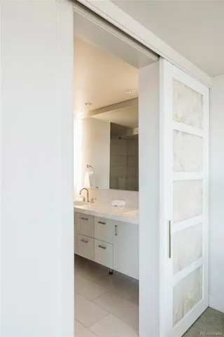 a bedroom with a bed and a night stand