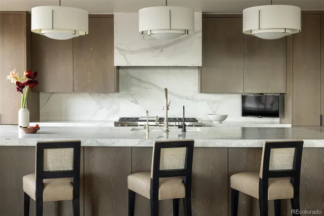 a kitchen with cabinets and chairs